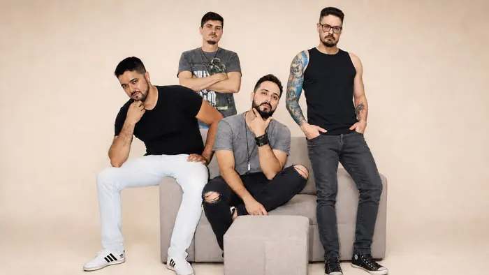 Integrantes da Dona Maria reunidos em um sofá